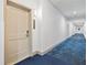 Building hallway with blue carpeting and light walls at 14501 Grove Resort Ave # 3137, Winter Garden, FL 34787