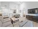 Open concept living area with dining table and gray sectional sofa at 14501 Grove Resort Ave # 3137, Winter Garden, FL 34787