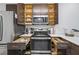 Modern kitchen with dark cabinets, stainless steel appliances, and open drawers at 14501 Grove Resort Ave # 3137, Winter Garden, FL 34787