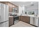 Modern kitchen with stainless steel appliances and dark cabinets at 14501 Grove Resort Ave # 3229, Winter Garden, FL 34787