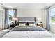 Main bedroom with king bed, nightstands, and large windows at 557 Zinfandel Dr, Holly Hill, FL 32117