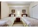 Bright bedroom with two twin beds, nightstand, and window at 13427 Blue Heron Beach Dr # 1004, Orlando, FL 32821