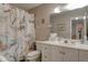 Bathroom with white vanity, shower, and marble shower curtain at 5875 Talavera St, Orlando, FL 32807