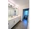 Double vanity bathroom with white cabinets and gray tile floor at 17930 Adrift Rd, Winter Garden, FL 34787