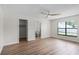 Bright bedroom with wood-look floors and an ensuite bathroom at 137 Birmingham Dr, Kissimmee, FL 34758