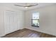 Bright bedroom with wood-look floors, large closet, and ceiling fan at 137 Birmingham Dr, Kissimmee, FL 34758