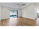 Bedroom with wood-look floors, sliding door to patio, and ensuite bathroom at 137 Birmingham Dr, Kissimmee, FL 34758