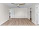 Spacious bedroom with wood-look floors and access to a closet at 137 Birmingham Dr, Kissimmee, FL 34758