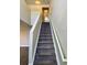 Carpeted staircase leading to the second floor at 104 Richmar Ave, Haines City, FL 33844