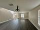 Bright living room with dark grey laminate flooring and chandelier at 104 Richmar Ave, Haines City, FL 33844