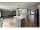 Modern kitchen with island, white cabinets and tile flooring at 104 Richmar Ave, Haines City, FL 33844