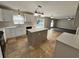 Modern kitchen featuring an island, white cabinets and tile flooring at 104 Richmar Ave, Haines City, FL 33844