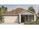 New construction home with two-car garage and blue siding at 1145 Brimstone Cir, Winter Haven, FL 33884