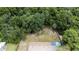 Aerial view showing home, expansive backyard, and surrounding trees at 22545 Orange Blossom Ln, Eustis, FL 32736