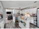 Open kitchen with white cabinets, marble countertops, and an island at 22545 Orange Blossom Ln, Eustis, FL 32736