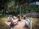 Charming backyard patio with fire pit and seating at 22545 Orange Blossom Ln, Eustis, FL 32736