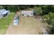 Aerial view of a mobile home on a large lot with detached shed and other structures at 22545 Orange Blossom Ln, Eustis, FL 32736