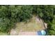 Aerial view of backyard with trampoline, fire pit, and above-ground pool at 22545 Orange Blossom Ln, Eustis, FL 32736