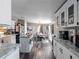 Open concept kitchen featuring white cabinets and an island at 22545 Orange Blossom Ln, Eustis, FL 32736
