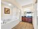 Bathroom boasts a large soaking tub and double vanity at 8112 Poinciana Blvd # 1305, Orlando, FL 32821