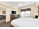 Comfortable bedroom with dresser and views to living area at 8112 Poinciana Blvd # 1305, Orlando, FL 32821
