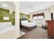King-size bed and jacuzzi tub in a relaxing bedroom at 8112 Poinciana Blvd # 1305, Orlando, FL 32821