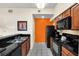 Modern kitchen with black appliances and granite countertops at 8112 Poinciana Blvd # 1305, Orlando, FL 32821