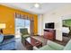 Spacious living area with sofa, chairs, and view into bedroom at 8112 Poinciana Blvd # 1305, Orlando, FL 32821