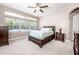 Primary bedroom with carpeted floor, large windows, and ceiling fan at 4783 Cains Wren Trl, Sanford, FL 32771