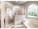 Bathroom with shower, tub, and large window at 4783 Cains Wren Trl, Sanford, FL 32771