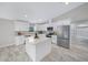 Modern kitchen with white shaker cabinets and a large island at 6260 Sw 144Th Lane Rd, Ocala, FL 34473