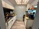 Kitchen with white cabinets and laminate flooring at 34 Saint Andrews Ct, Kissimmee, FL 34759
