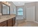 Relaxing bathroom with soaking tub, single vanity, and tile floors at 8368 Rambling River Dr, Sanford, FL 32771