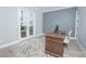 Bright home office with gray accent wall, hardwood floors, and backyard view at 7967 Nemours Pkwy, Orlando, FL 32827