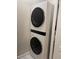 Convenient laundry room with stacked LG ThinQ washer and dryer at 9101 El Caro Ln, Davenport, FL 33896