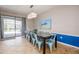 Bright dining room with glass table and teal chairs at 9101 El Caro Ln, Davenport, FL 33896