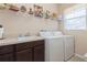 Laundry room with washer, dryer, and storage shelves at 5388 Via Appia Way, Sanford, FL 32771