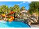 Resort-style pool with waterslide and waterfall feature at 7184 Oakmoss Loop, Davenport, FL 33837