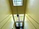 View of a bright stairwell with a window and light fixture at 3970 Versailles Dr # 3970B, Orlando, FL 32808