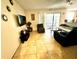 Living room with tiled floors, sofas, and patio access at 3970 Versailles Dr # 3970B, Orlando, FL 32808
