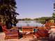 Relaxing patio furniture overlooks a serene lake at 3970 Versailles Dr # 3970B, Orlando, FL 32808