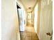 Long hallway with multiple doors leading to bedrooms at 3970 Versailles Dr # 3970B, Orlando, FL 32808