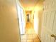 Clean hallway with tile flooring and neutral walls at 3970 Versailles Dr # 3970B, Orlando, FL 32808