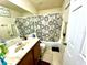 Bathroom with tub shower and wood vanity at 3970 Versailles Dr # 3970B, Orlando, FL 32808