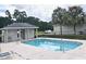 Community pool with a surrounding fence and lounge chairs at 3415 W Anthony Rd # 706, Ocala, FL 34475