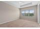 Main bedroom with carpeted floor, ceiling fan, and large window at 15119 Kirsty Aly, Winter Garden, FL 34787