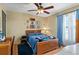 Bedroom with a full-size bed, wooden dresser, and blue bedding at 675 Shady Nook Dr, Clermont, FL 34711