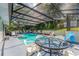 Relaxing pool area with screened patio, glass top table, and comfortable seating at 675 Shady Nook Dr, Clermont, FL 34711