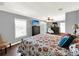 Cozy bedroom with a queen-size bed and sitting chair at 102 Via Duomo, New Smyrna Beach, FL 32169