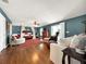 Main bedroom with hardwood floors, seating area, and canopy bed at 102 Via Duomo, New Smyrna Beach, FL 32169